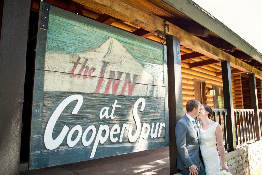 Wedding Couple Kissing Outside Main Lodge (with Rooms and Condos)- Lodging at Cooper Spur Mountain Resort